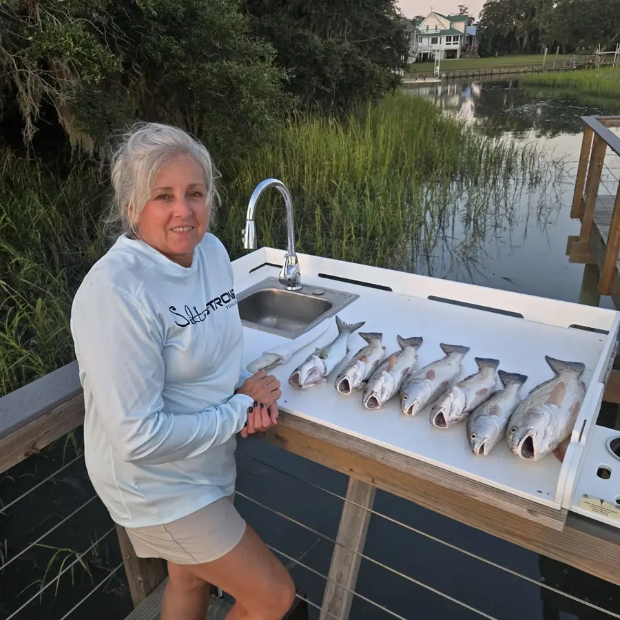 Founder of Aqua Marine Customs at the dock cleaning station with the day's catch
