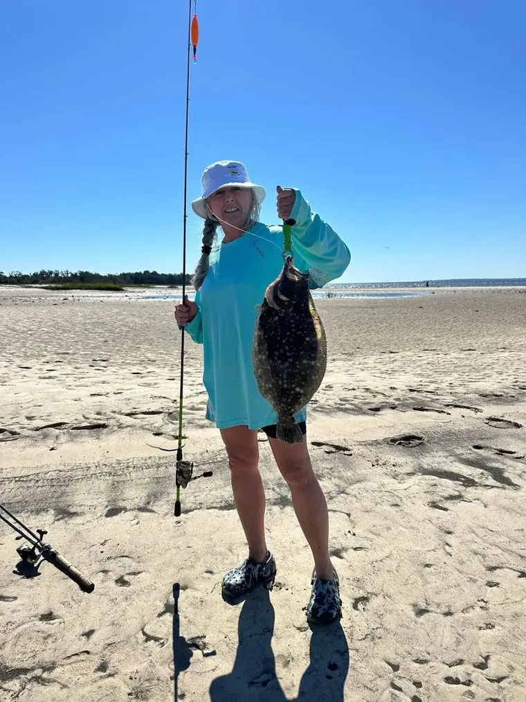 Founder of Aqua Marine Customs holding a flounder on a South Carolina beach